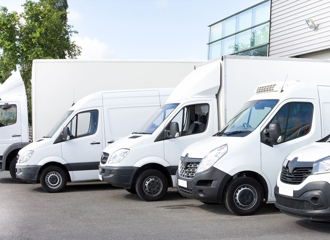 Business Insurance - Several Cars, Vans , and Trucks Parked in the Company Parking Lot for Rent or Delivery