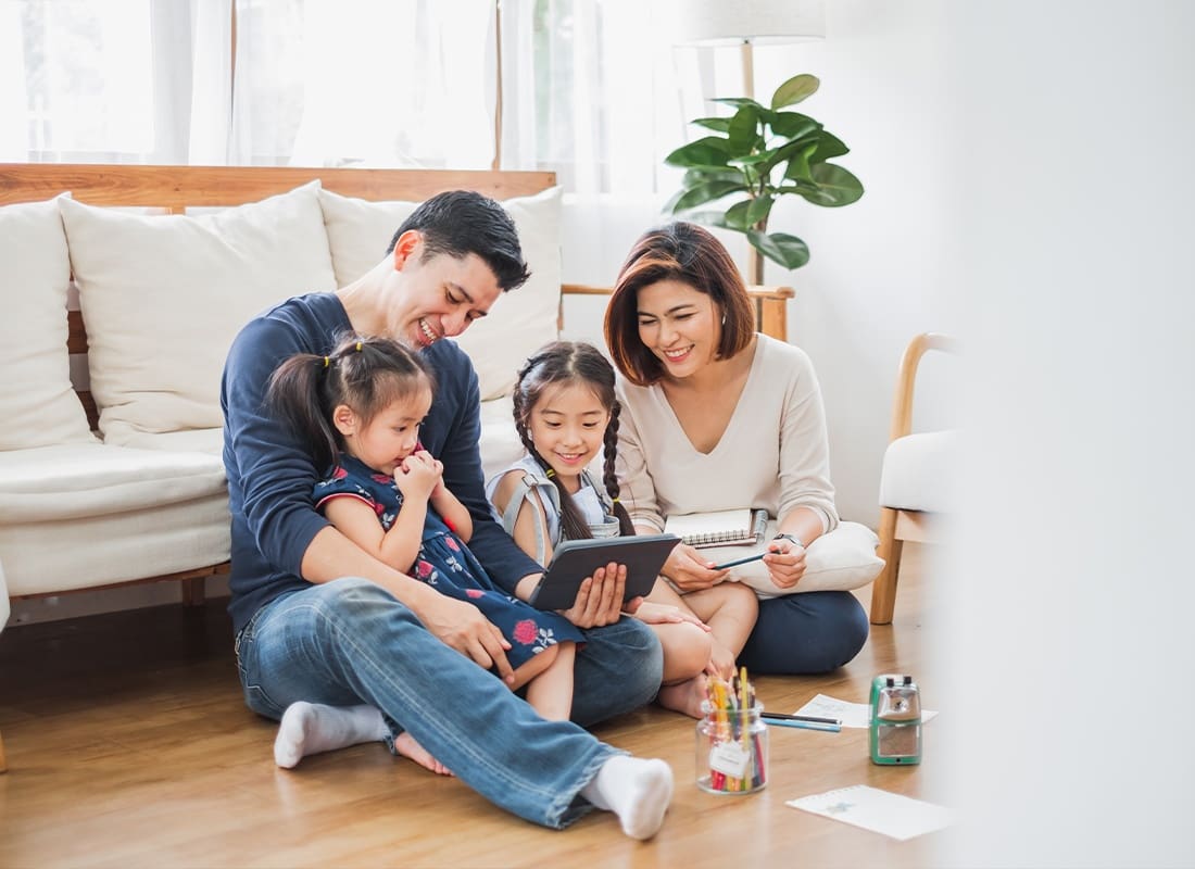Life & Health - Happy Family Using a Tablet for Playing Games, Watching Movies, and Relaxing at Home