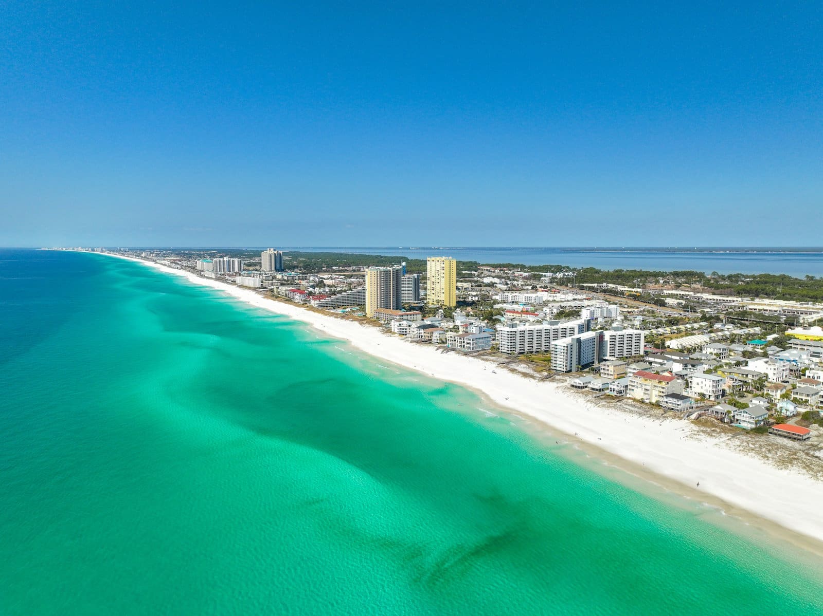 Aerial view of beachfront condos along Florida's Emerald Coast near Miramar Beach and 30A.