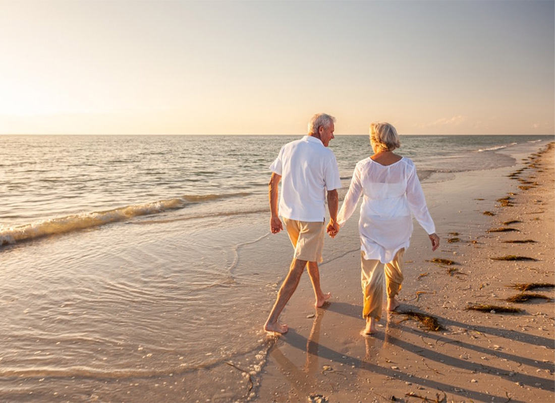 Retired couple walking on the beach at sunset in Santa Rosa Beach on Florida's 30A