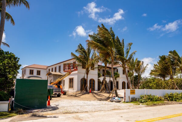 Coastal Florida home under construction with crane and framing crew near Santa Rosa Beach
