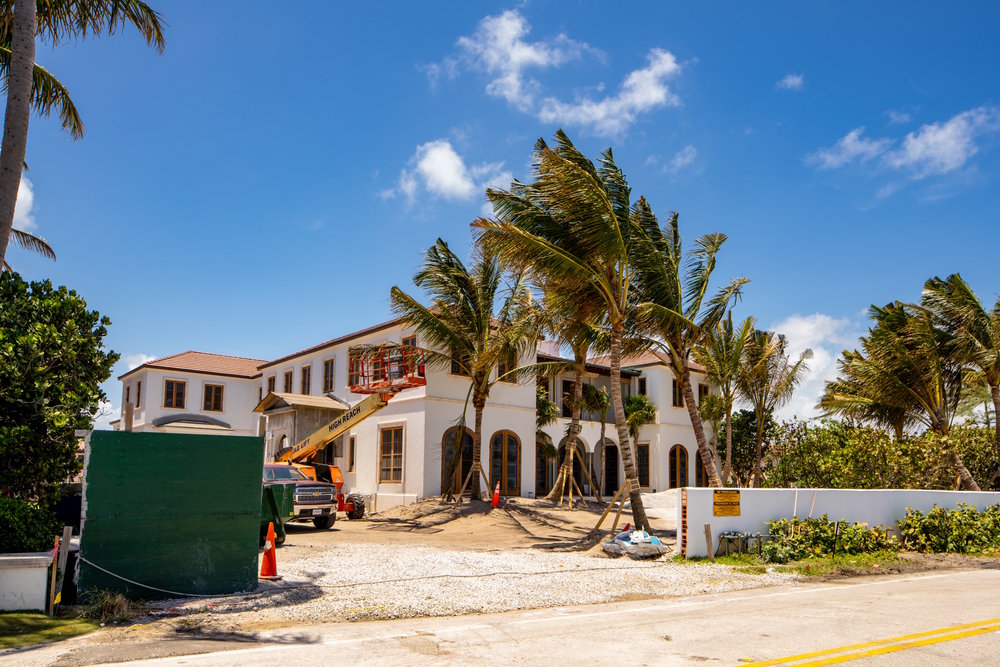 Coastal Florida home under construction with crane and framing crew near Santa Rosa Beach